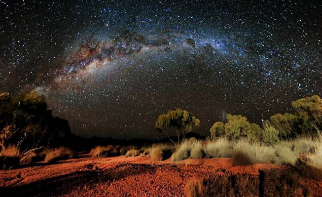 Light captures the red dirt around Winton and the Milky Way lights the night sky.