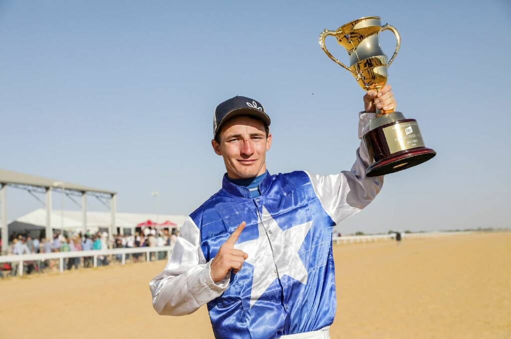 Rider Clayton Gallagher holds the Birdsville Cup aloft after a dramatic win in the $40,000 event on the Todd Austin-trained French Hussler. Photo Salty Dingo