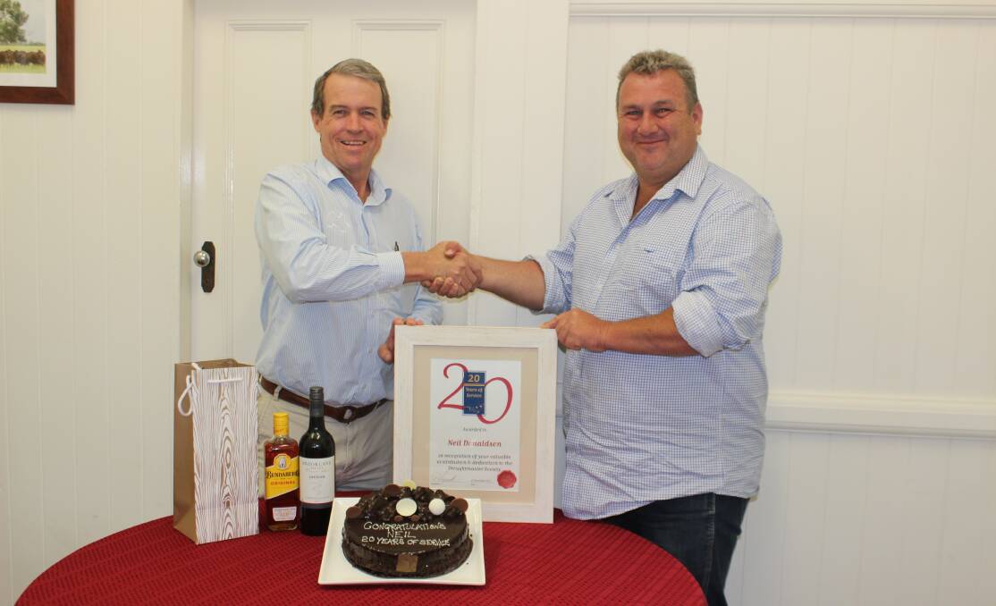 Better terms: Outgoing Droughtmaster Australia Society CEO, Neil Donaldson received a warm congratulations from former president Paul Laycock, during a celebration for Neil’s 20 years of service in 2017. Photo by Sharon Harms.
