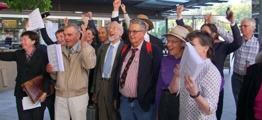 Landholders celebrate outside the court on Wednesday. 