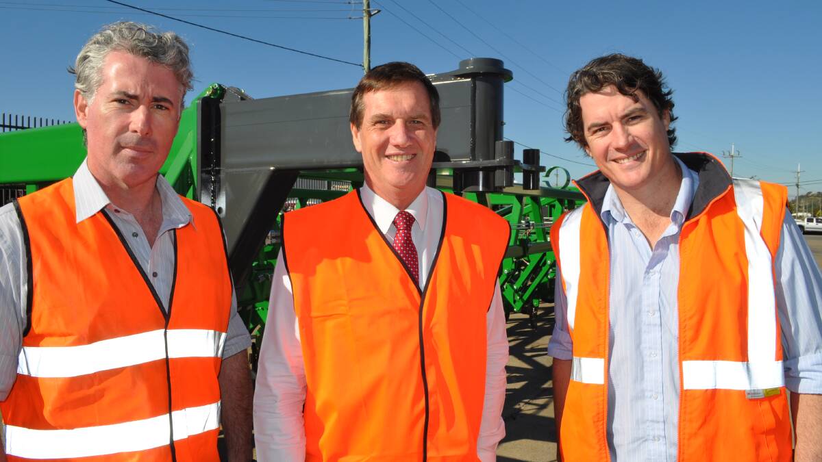 Michael O'Connor with State Development Minister Dr Anthony Lynham and brother Jim O'Connor in front of their new 36 metre Patriot Planter.