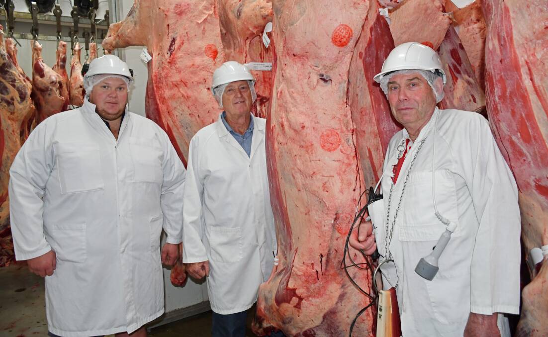 Abattoir manager Ben Cooper, Carey Brothers owner Greg Carey and Bruce Sutton celebrate Mr Sutton's last day at the Yangan facility after 50 years. Picture: Billy Jupp