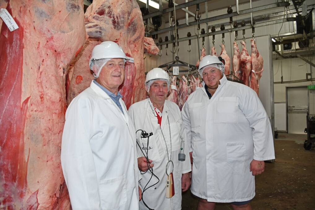 Carey Brothers owner Greg Carey, Bruce Sutton and abattoir manager Ben Cooper celebrate Mr Sutton's last day at the Yangan facility after 50 years. Picture: Billy Jupp