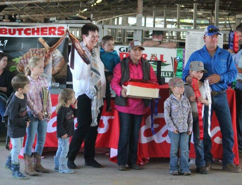 Dell Patterson with relatives of life member George Perkins presenting the Bully Brown Memorial Trophy for junior exhibitor to Mackenzie Bartlett and reserve champion Savannah Mortimer.