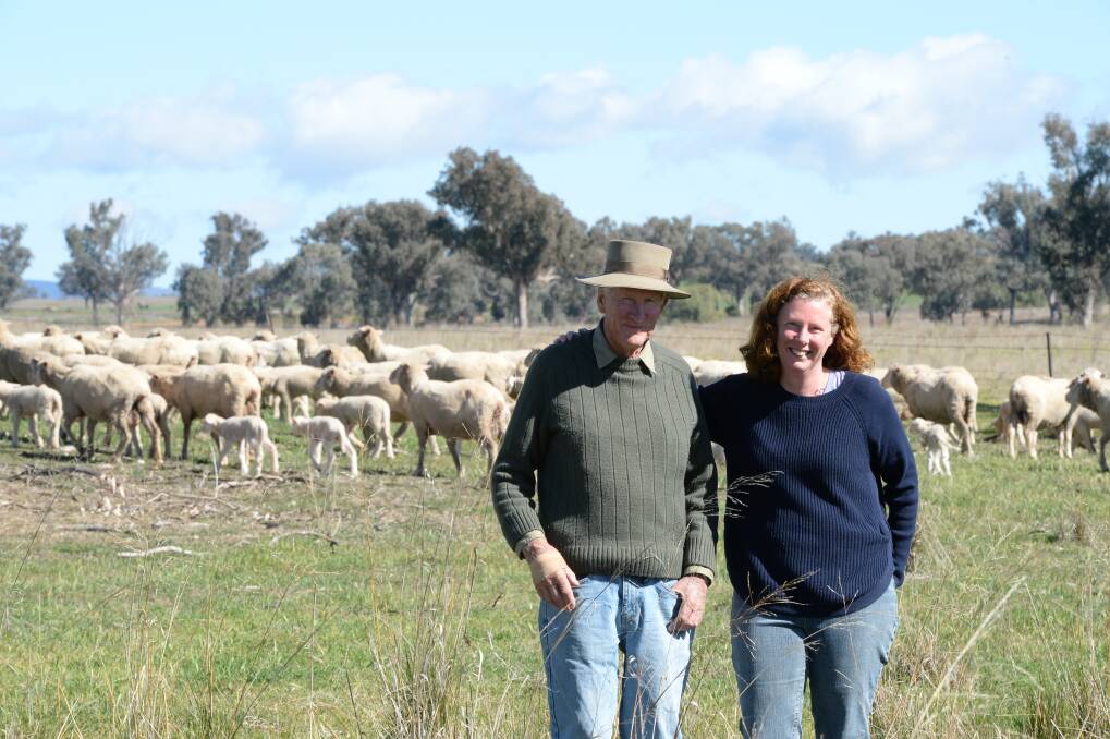 
David Gowing and his daughter, Stephanie Cayley, with Merino ewes at "Wyoming", Tamworth.