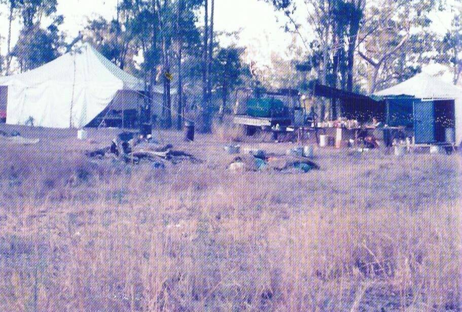 OUTDOOR OFFICE: A shot from the book of the Arvale poisoning camp at Theodore in 1976, a typical setup for Arthur Dingle's timber clearing operation.