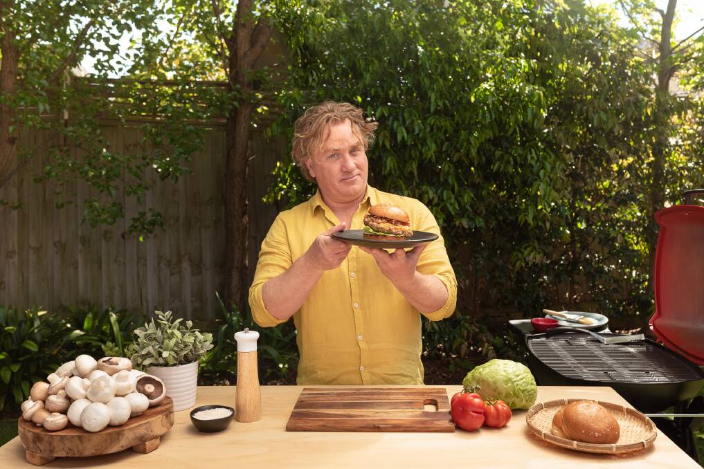 MEATY: Celebrity chef Adrian Richardson with a Japanese Miso pork and mushroom blended burger. Mr Richardson is encouraging consumers to replace some dietary meat with blended mushrooms.