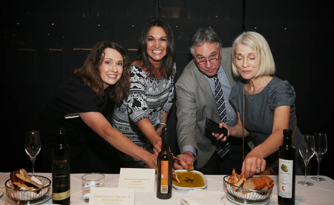 EAT UP: ABC Radio's Chris Bath, dietitian and nutrition scientist Dr Joanna McMillian, Australian Olive Association executive officer Greg Seymour and The Food Coach Judy Davie, getting into the spirit of the AOA media lunch. 