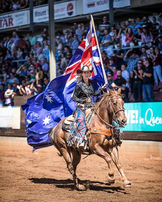 PROUD MOMENT: Reigning Miss Rodeo Australia Emma Deicke carries the Australian flag at the Wagga Wagga Rodeo. Picture: Stephen Mowbray