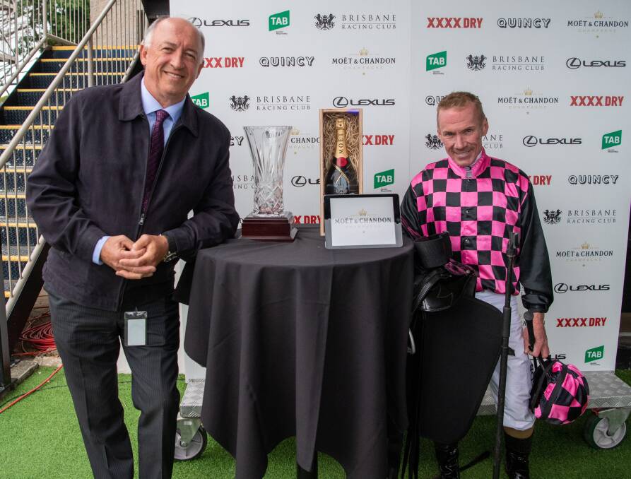 Brisbane trainer Rob Heathcote and jockey Jim Byrne with the Group 2 Moet and Chandon Champagne Classic trophies won by 2YO gelding Rothfire at Eagle Farm. Picture: Racing Queensland
