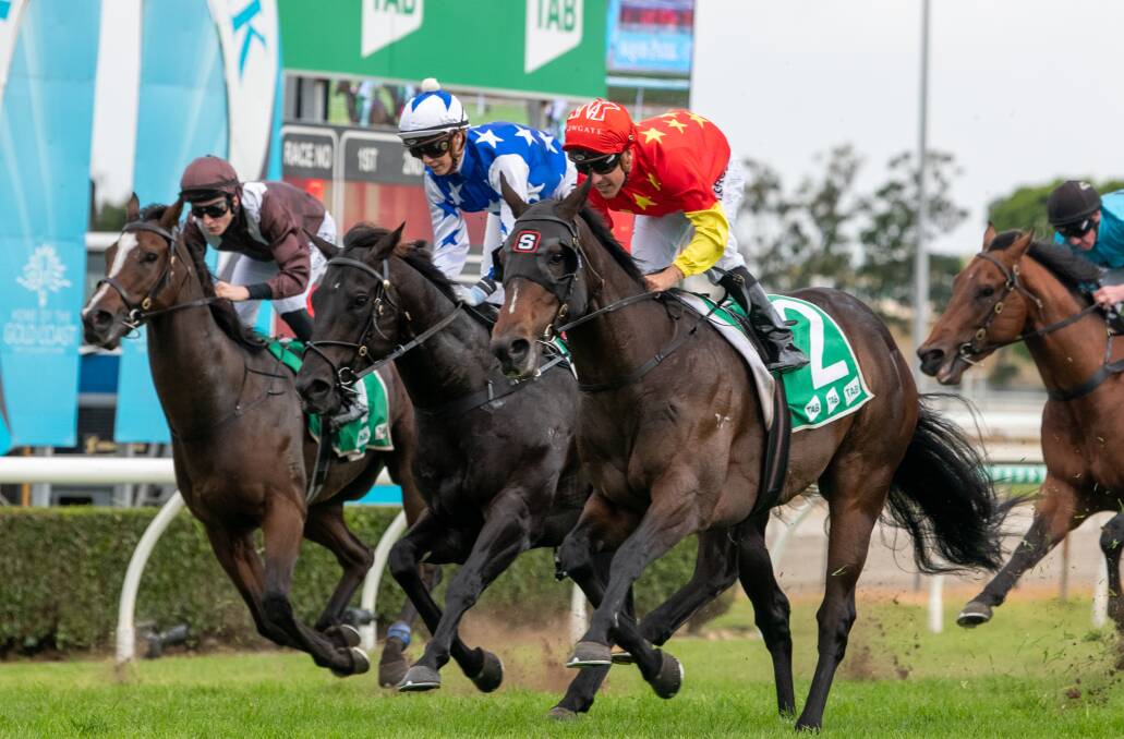 Sydney trained Hightail (red colours) ridden by Ryan Moloney narrowly wins the Gold Coast Guineas from Brisbane trained The Odyssey (blue colours) ridden by Stephanie Thornton. Second prize money was sufficient to lift The Odyssey past the $1 million prize money mark. Picture: Racing Queensland
