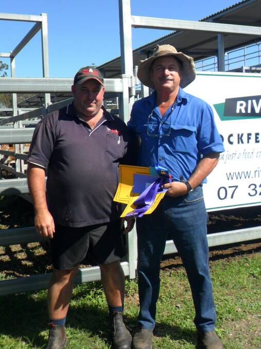 David Trewin (right) of Tru Investments, Beaudesert won champion pen of the show with his Charolais cross weaner steers. The award was presented by judge Paddy Brosnan of N & P Wholesale Meats.