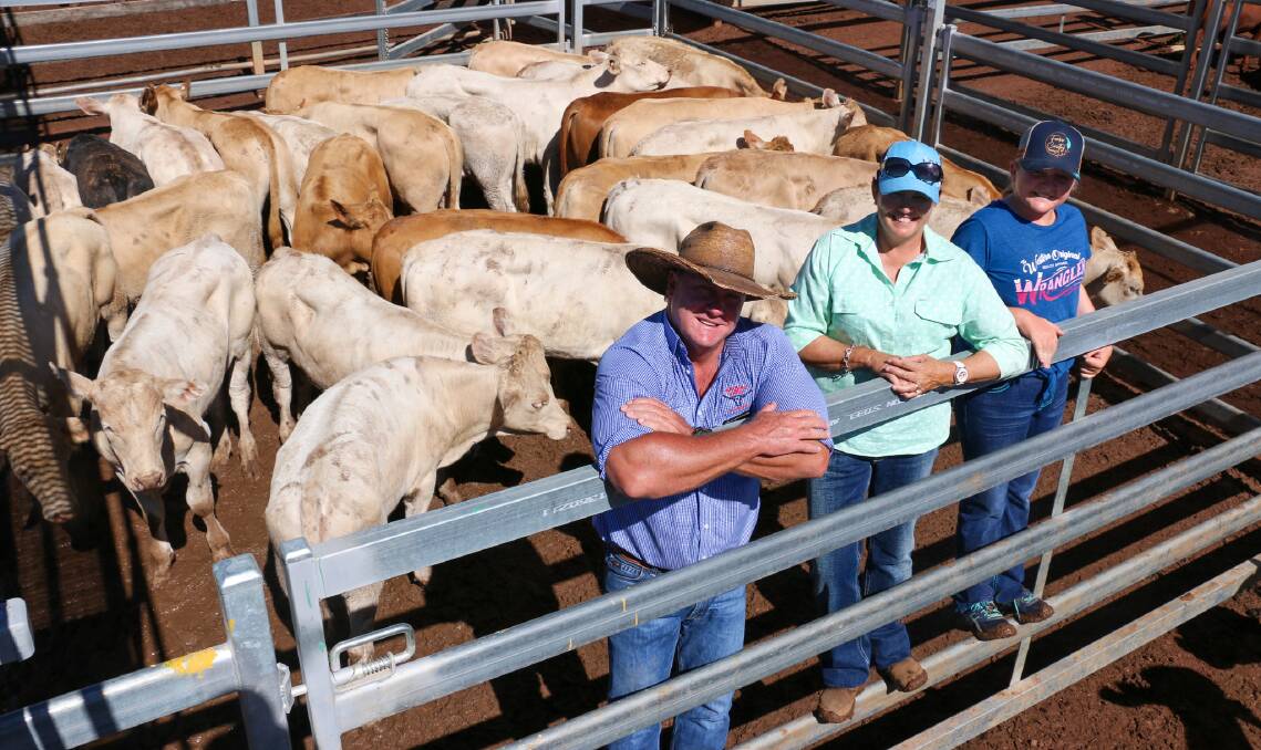 Watkins and Co agent Brad Neven and vendors Maryanne and Kymberlee Russell with a pen of SD & MJ Russell steers that sold to 618c/kg, reaching a top of $1850 to average $1690.