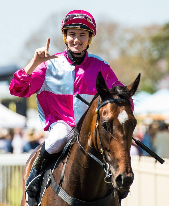 Jockey Michael Hellyer gestures after riding Baccarat Baby to victory in the QTIS Three-Years-Old Handicap at Doomben last September. (AAP Image/Albert Perez) 