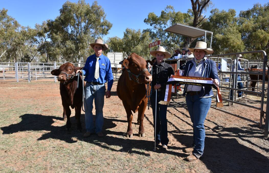 TERRIFIC DUO: Will Turner, Alice Springs, holds the calf of supreme female Miss Impatience, held by Brooke Weir and sashed by Rebecca Skene.