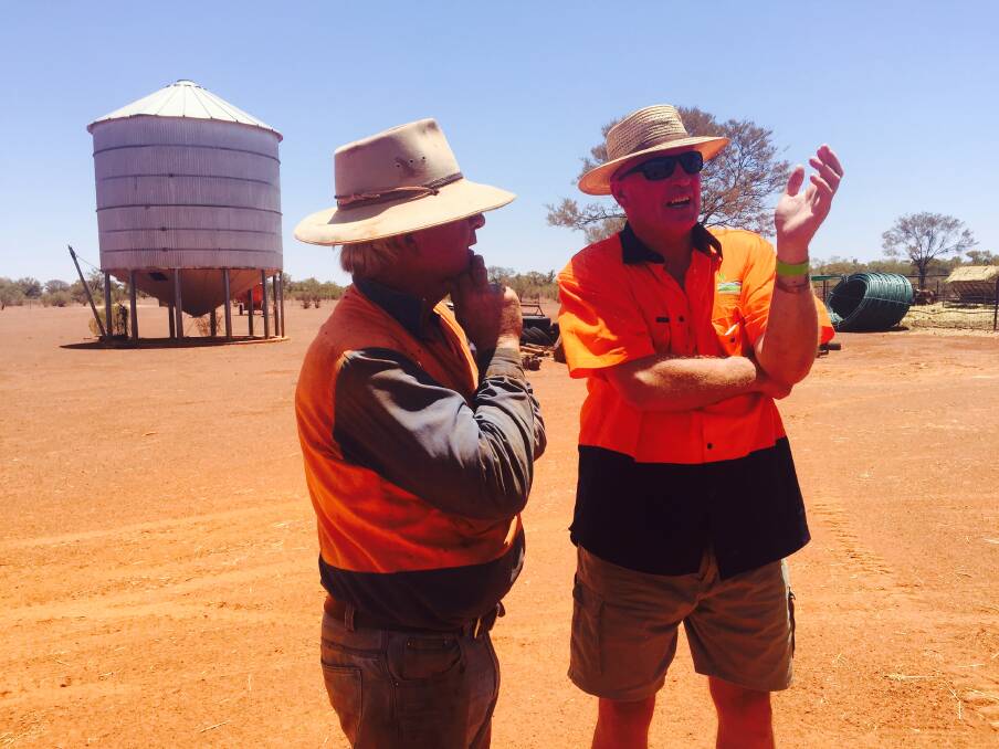 HAY DAY: Eulo farmer Shane Warner speaks with Jindera hay runner Jim Parrett during the delivery.
