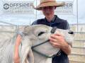 Brahman breeder and stud student Daniel Prior, Bellingen, cradling Mountana Anastasia, 10 months, a new recruit into the Mountana stud at Kyogle, pictured during the Primex exhibition.