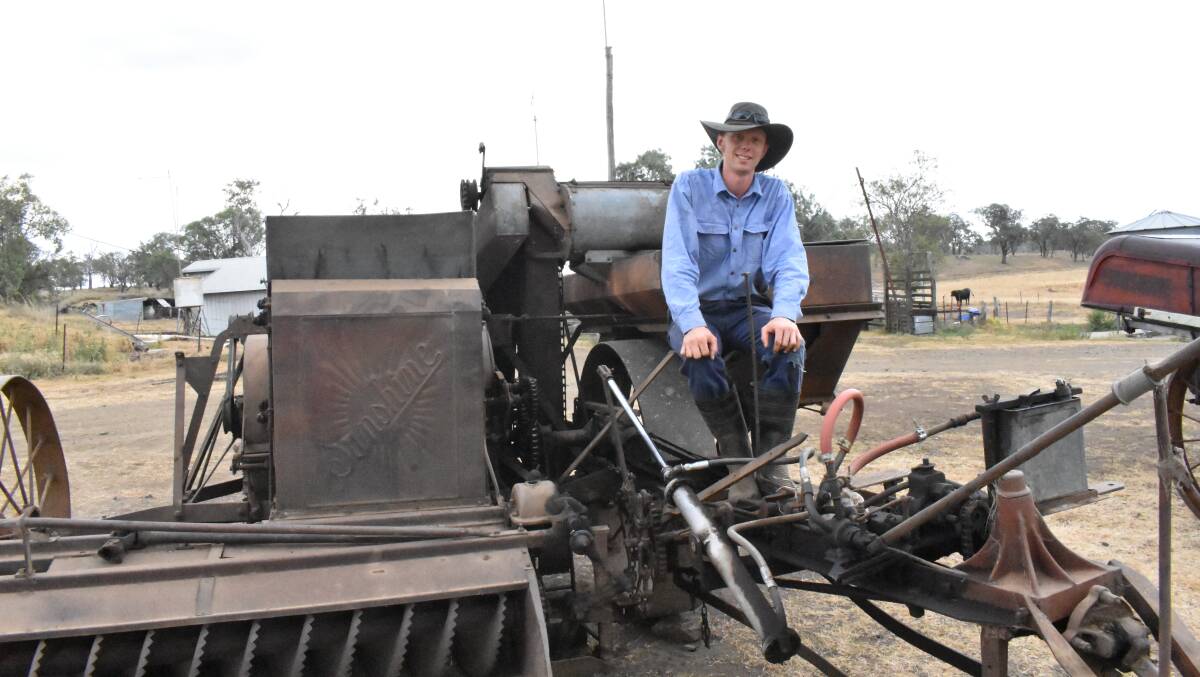 Passion project: Darling Downs-based apprentice Mark Sheppard on top of the 1940s Sunshine Harvester he bought and began restoring in his late teens. 
