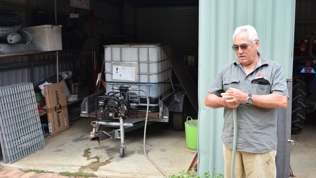 Paul rigging up his new 1000l water tank after last summer's bushfires. 
