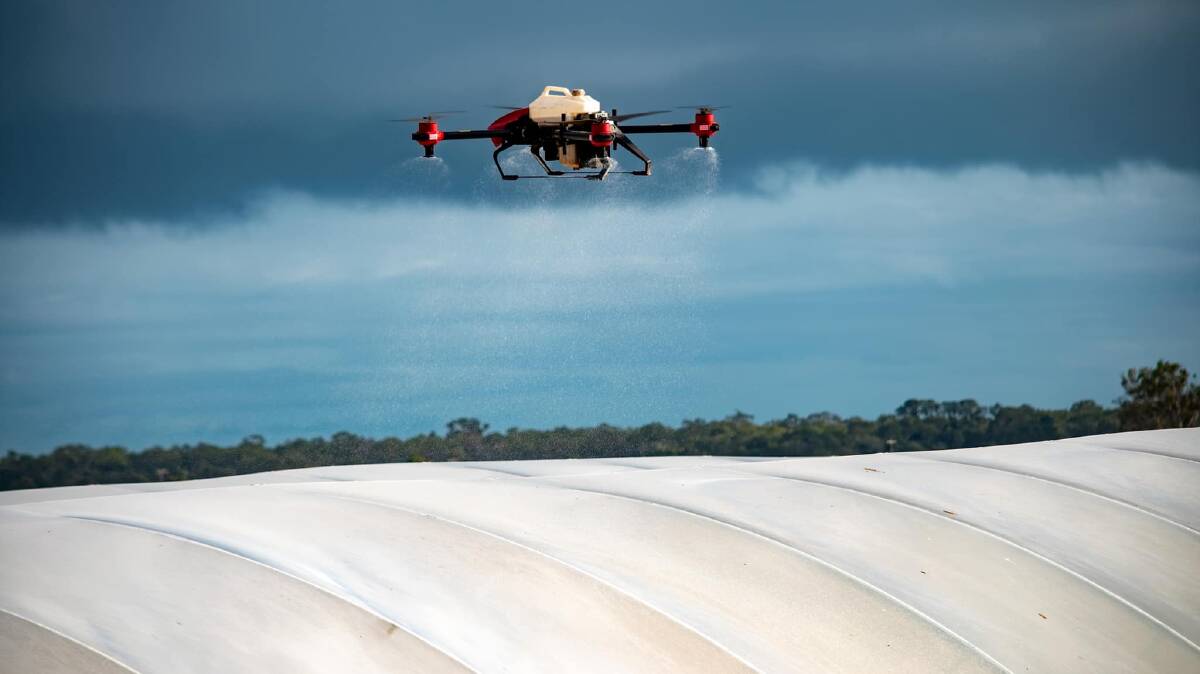 OzTech Drone being used to paint a green house with a water based UV treatment to reduce heat penetrating. 