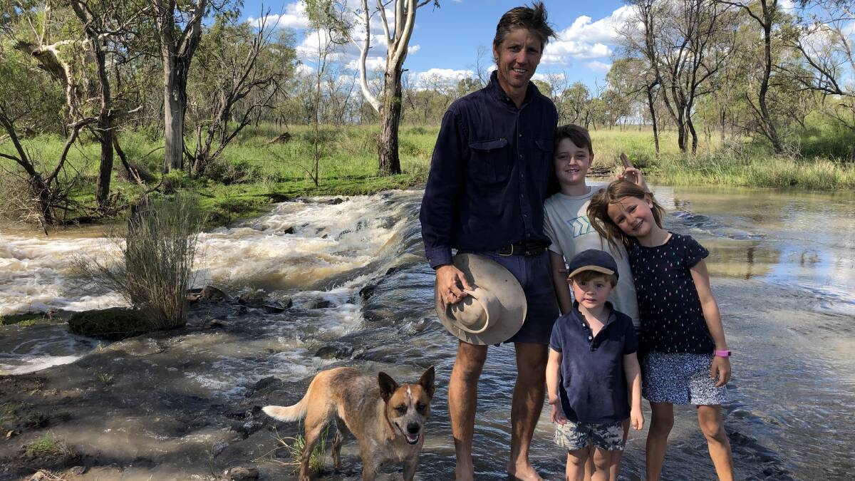 Central Downs Irrigators treasurer Lindsay Krieg Charlie, Owen and Evelyn Krieg enjoy the rushing water of the North Branch of the Condamine River. 