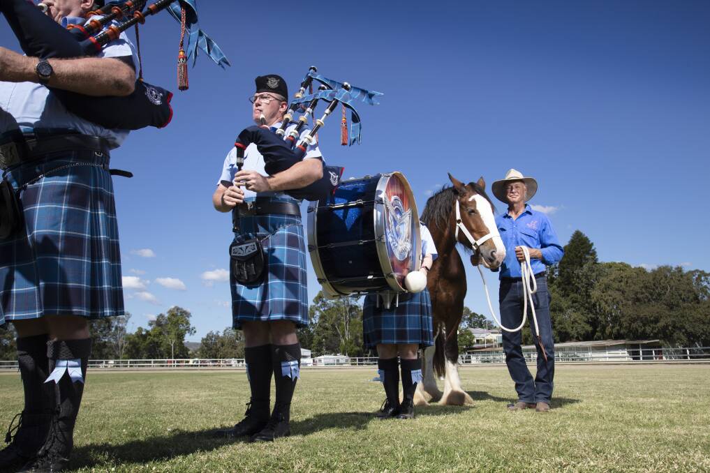 MARCHING ON: Clydesdale Spectacular returns to the Scenic Rim. Organiser Rick Stanfield with Scottish pipe band. Supplied.