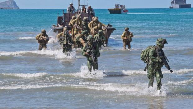 Australian Army soldiers from 7th Battalion, Royal Australian Regiment, and Singapore Army soldiers disembark a Fast Craft Utility landing vessel at Shoalwater Bay training area, Queensland. Photo: CPL David Cotton