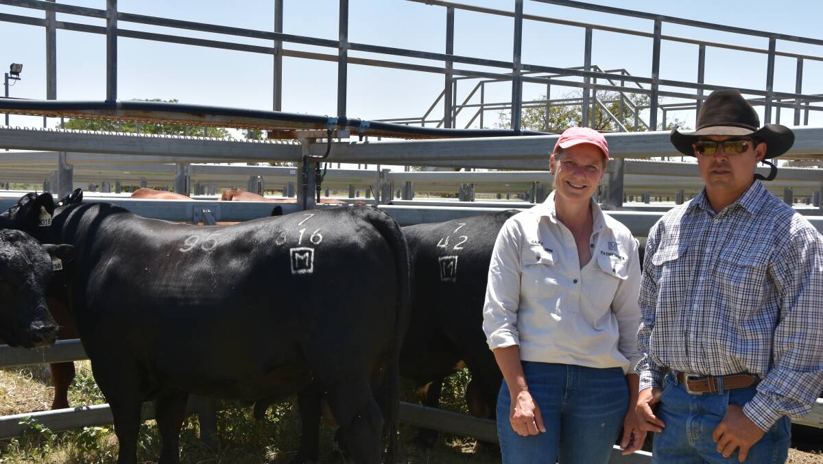 Sara Moyle from Pathfinder Angus stands with Gary Masters, who bought top-priced bull Pathfinder N316 (lot 95) for the Fairview Cattle Company. 
