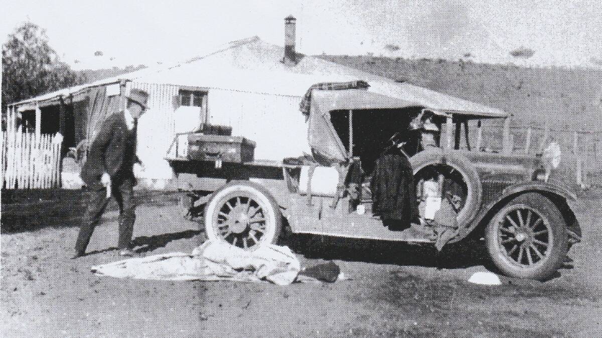 A photograph of Reverend John Flynn preparing for an outback trip, taken around 1924. 