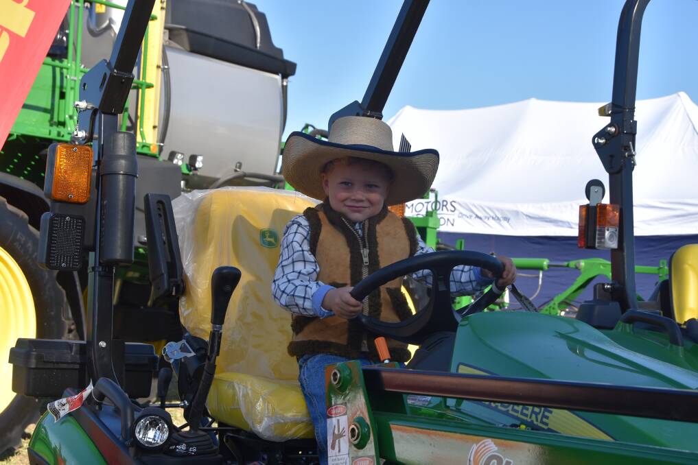 Young Hank McCartney, 5, Duaringa, getting a feel of what it's like to be behind the wheel of a John Deere tractor. Pictures: Ben Harden