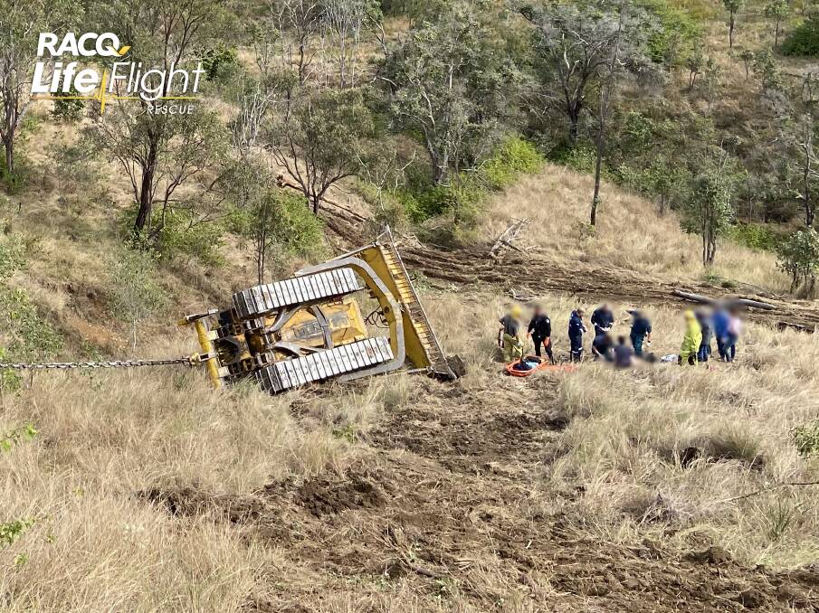 A man was seriously injured in a bulldozer rollover in rugged terrain near Booubyjan on Wednesday. Picture: RACQ LifeFlight 