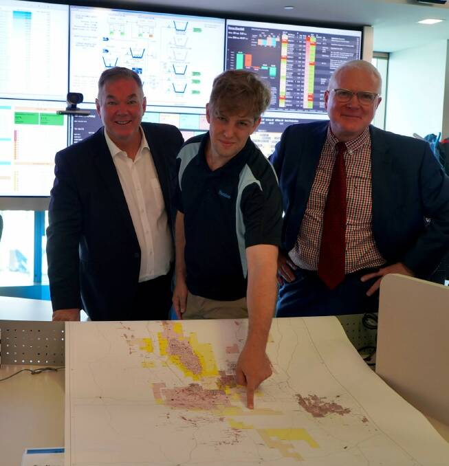 Resources Minister Scott Stewart looks over the land parcel with Santos Production Engineer Paul Weller and Santos Executive Vice President Onshore Oil and Gas Rob Simpson. 