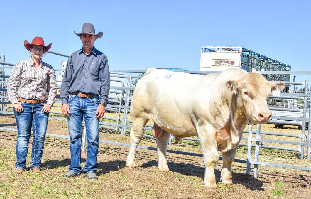 Amy Whitechurch of 4 Ways Charolais, Inverell, NSW, and Shane Murphy of Tayglen, Dysart, with top price bull 4 Ways MK R18E (P), who sold for $28,000. Pictures: Ben Harden