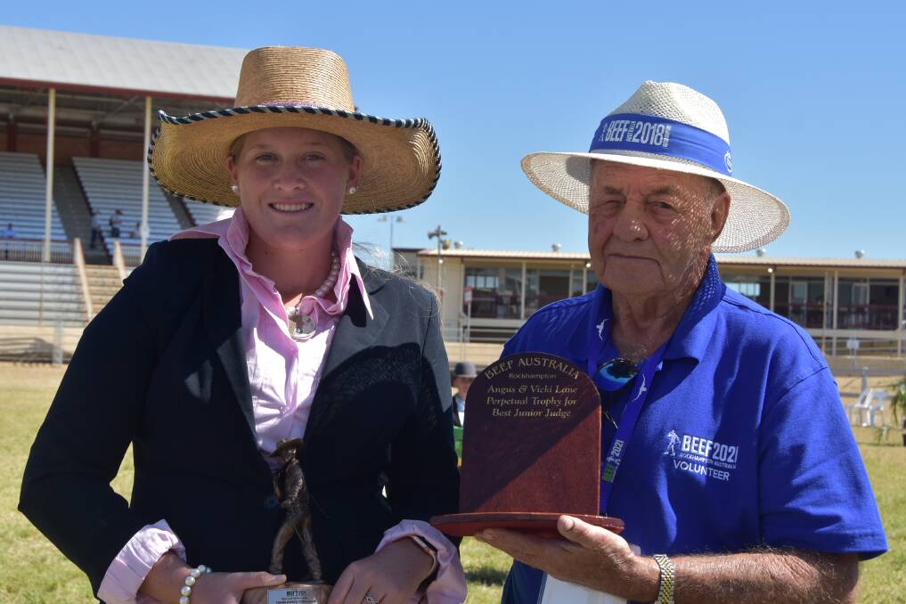 Maddison Rose is presented with the Beef Australia Angus and Vicki Lane perpetual trophy for best junior judge by Don Bellert, Rockhampton. Picture: Ben Harden