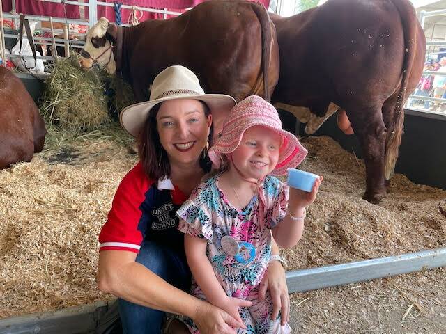 Keppel MP Brittany Lauga with her daughter Odette in the cattle pavilion at Beef 2021 in Rockhampton earlier this year. Photo: Supplied