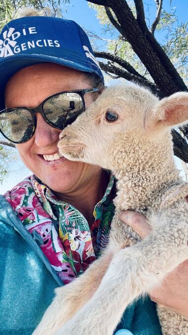 Bec Climie delivers a poddy lamb on the Kynuna mail run. Picture supplied.