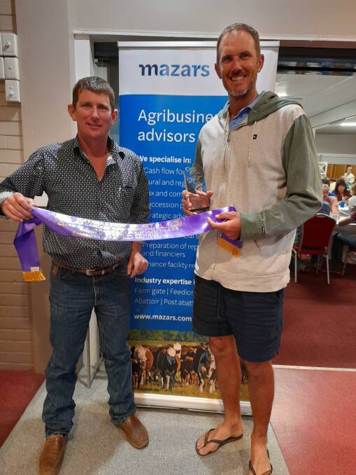 Barry McIntyre of Nolan Meats presents Lance Baker with top place for a single steer or female suitable for the Japanese grain-fed trade.