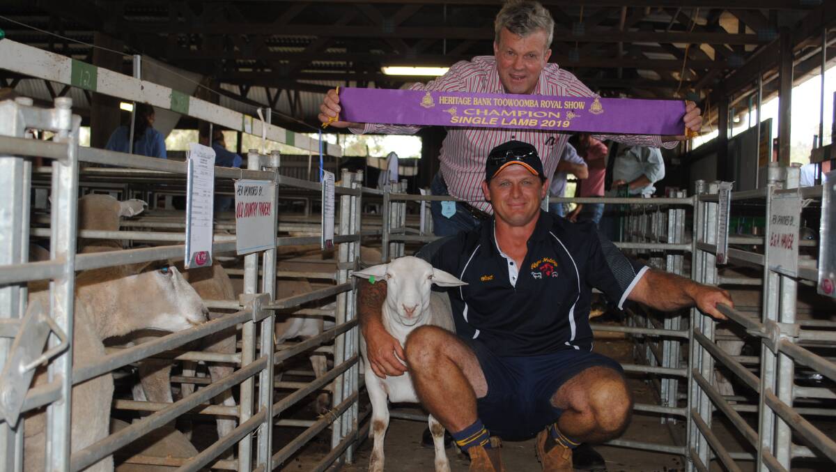 Scott Mengel, Rhyre Holdings, won the prize for champion single lamb, pictured with  judge Peter Sealy (back). 