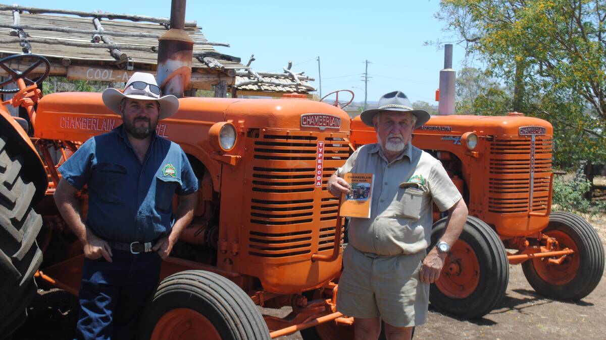 Josh and Melvin Mengel with some of the Chamberlain tractors on display for the book launch. 