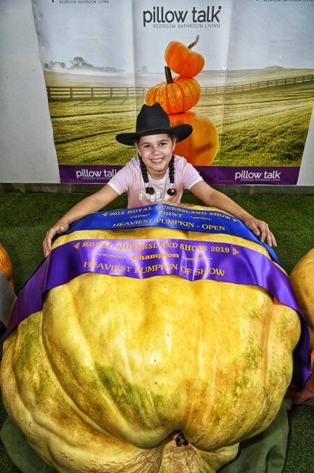 Youth Category winner Kyla-Shaye Fritz (9 years old) of Thagoona near Ipswich and the Grand Champion Pumpkin.