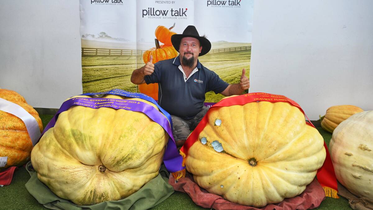 
Tony Frohloff of Minden, Queensland with his first and second place winning pumpkins. 