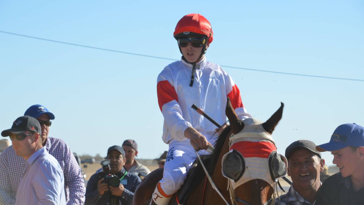 WINNING FEELING: Adin Thompson leads Blue Jest back to the winners enclosure after the Birdsville Cup. Photos: Derek Barry