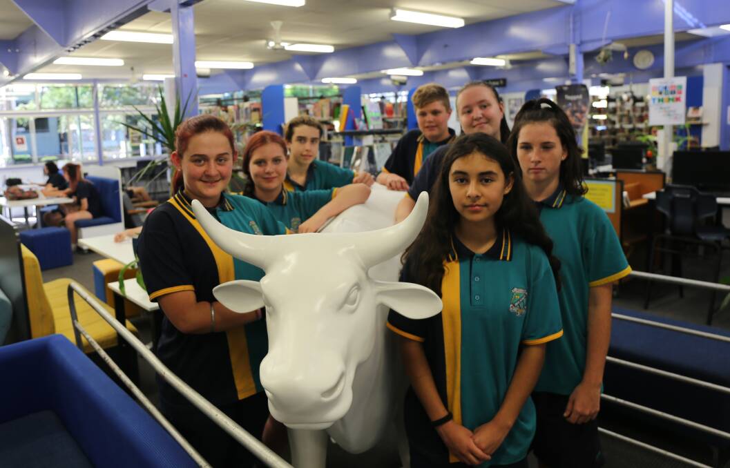 Year 8 and 9 students Bella Purvis, Amelia Bryan, Shane Bowater and Kane Rogers, Kasey Anderson, Andrea Tehan and Bella Goubaud with their blank canvas, the Archibull Prize entry.