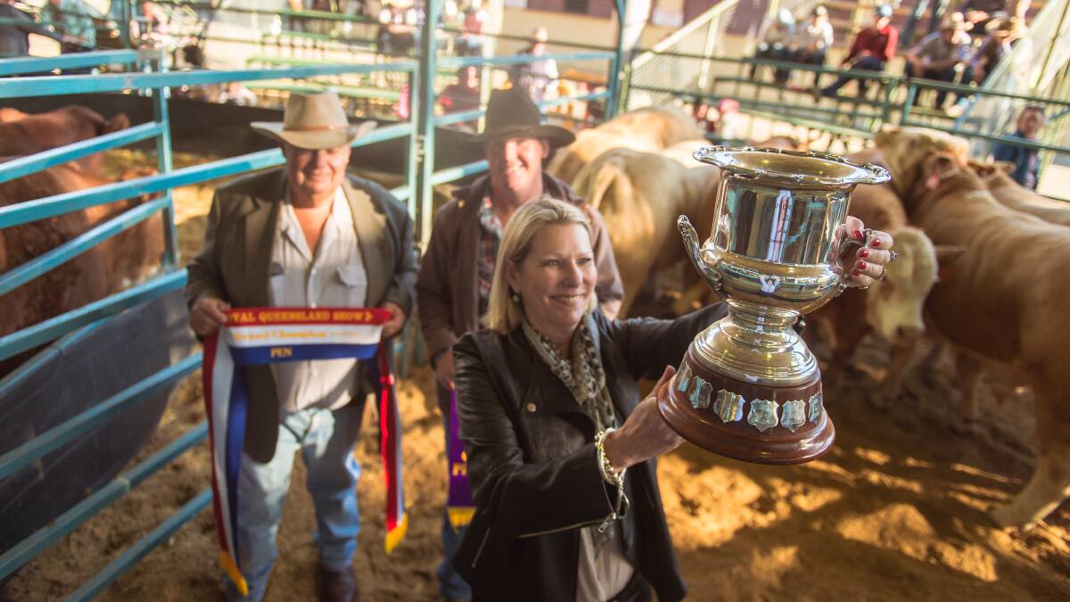 SUCCESS: Liz Cook, Ben Fogg and Noel Cook of Kindon, Goondiwindi, have taken home the grand champion prize for their pen of six at the Royal Queensland Show on Thursday. Photo: Kelly Butterworth