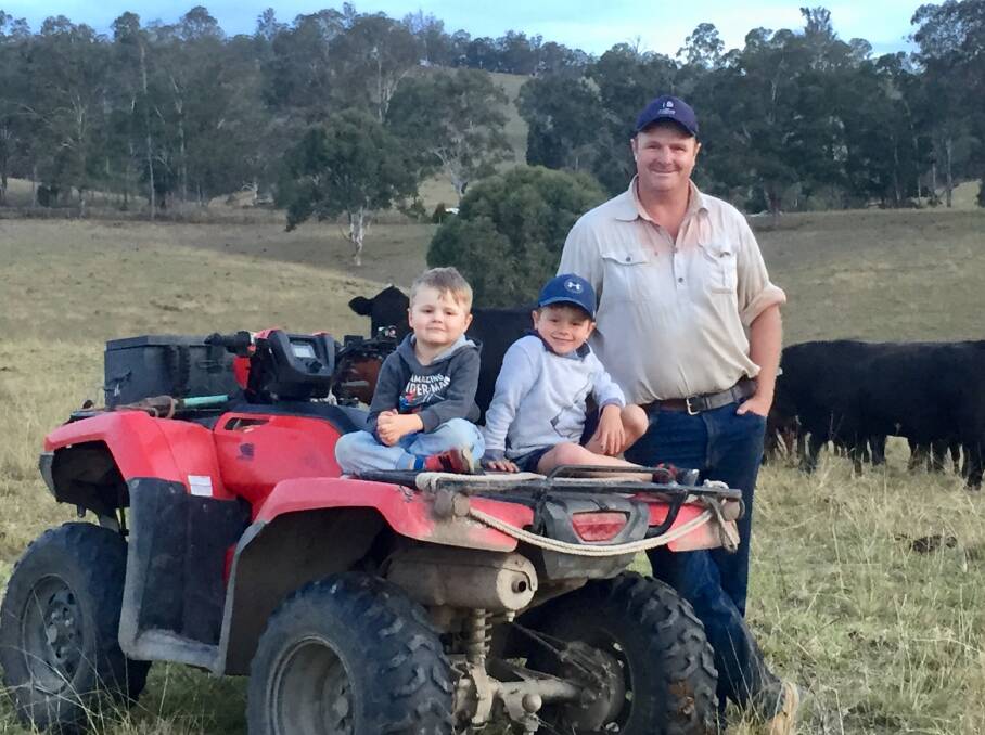 STOCK CHECK: Jamie Andrews checks stock with sons William, 4, and Mitchell, 6, on their Gloucester, NSW, property