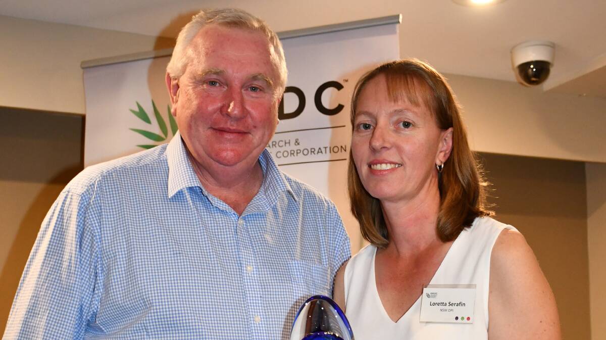 Grains Research Development Corporation northern panel chairman John Minogue awards NSW Department of Primary Industries researcher Loretta Serafin with the Seed of Light award. Picture: GRDC