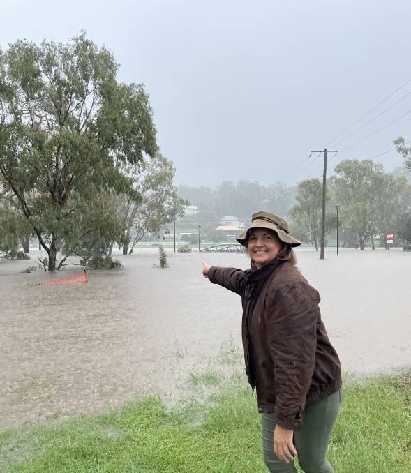 Warwick resident Belinda Williams inspecting the rising Condamine River on Tuesday afternoon. 