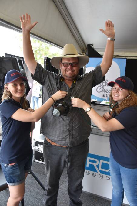 Familiar face: Ben Lobegeier received a health check at Beef 2015 and 2018. He is pictured in 2018 with UQ Rural Clinical School students Tamara Albairmanni and Sherice Ansell.