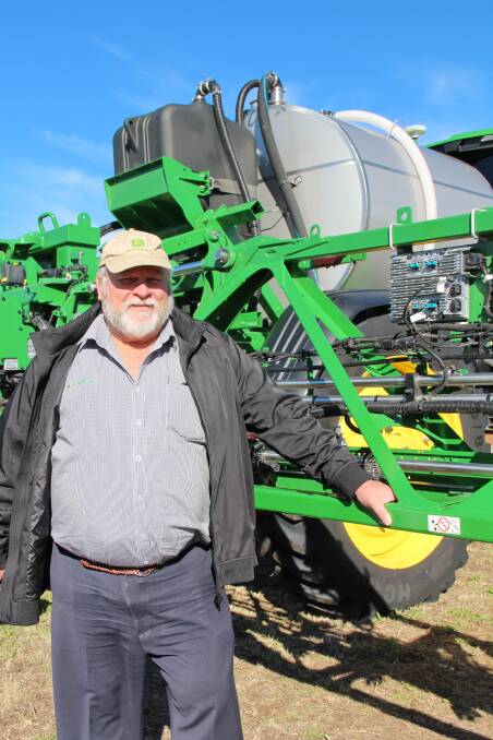 Vanderfield eastern regional manager Allan Cooper with the 120-foot John Deere 616R sprayer, which utilises See and Spray and ExactApply technology. 
