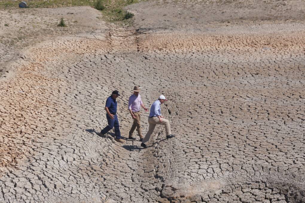Stanthorpe, QLD apple grower Dino Rizzato takes Drought Minister David Littleproud and Treasurer Josh Frydenberg across his dry dam earlier this month as the ministers toured drought hit regions.